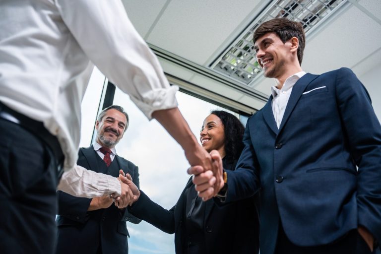 Caucasian businessman making a handshake together while stand in office.