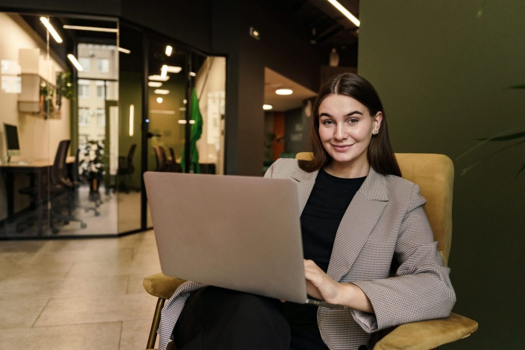 happy person in the office. Communicating online on social networks uses a laptop computer